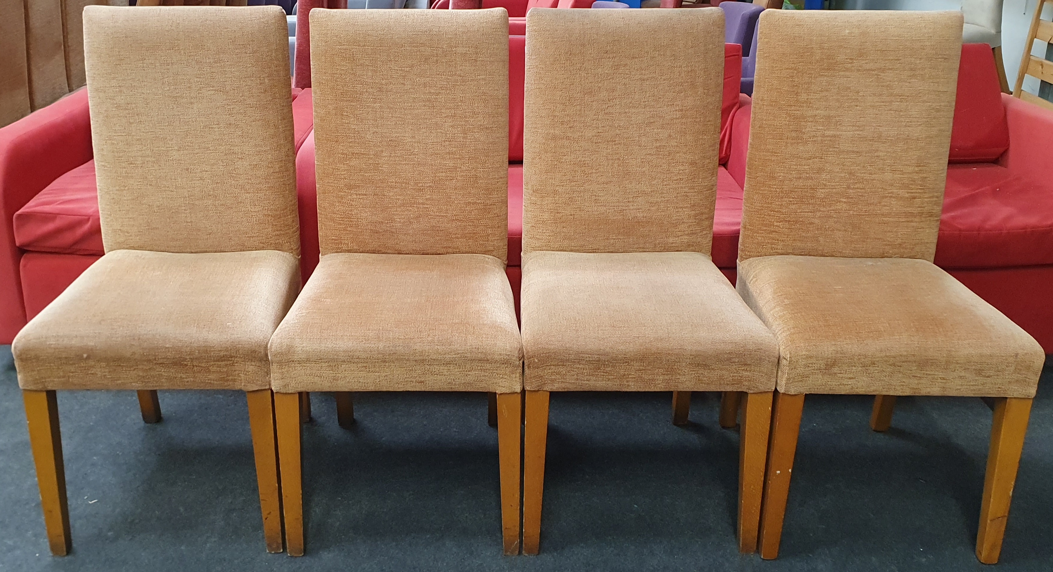 From a hotel clearance: Four dining chairs in light brown.