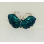 A large silver enamelled butterfly brooch.