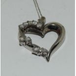 A 14ct white gold heart shaped diamond set pendant necklace.