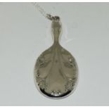 A silver looking glass pendant.
