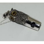 A silver owl shaped whistle on chain with glass eyes.