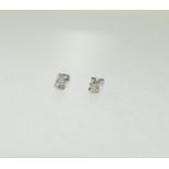 A pair of white gold diamond stud earrings.