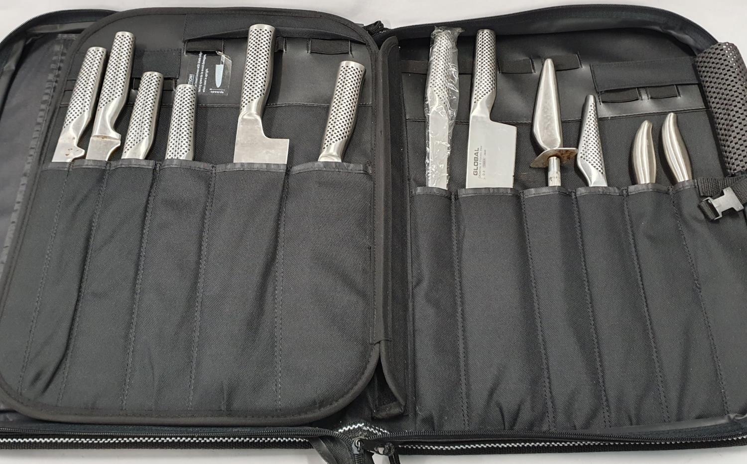 A cased set of 12 Global kitchen knives.