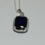 A silver CZ and Faux Sapphire pendant necklace (cased).