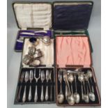 Boxed flatware and silver napkin rings and other misc silver.