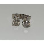 A pair of 14ct white gold Diamond Stud Earrings of 63 points.
