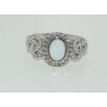 A silver CZ and opal paneled Art Deco style ring.
