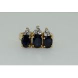 A Vintage three stone sapphire & 18ct gold diamond ring, 6.6grams, Size L