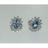 A pair of 9ct white gold Aquamarine and Diamond cluster earrings 1.4ct.