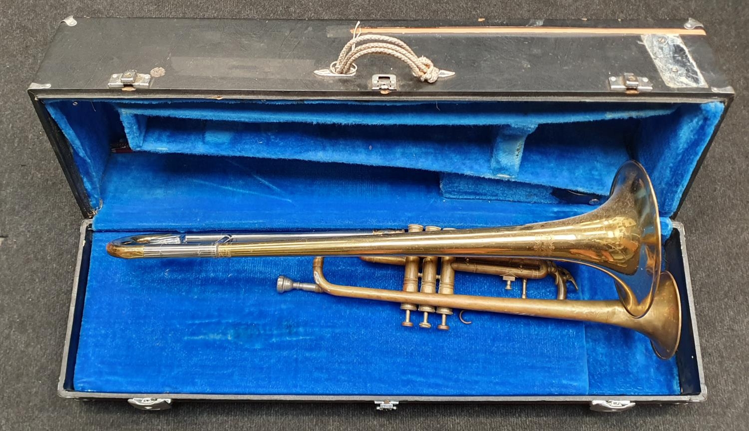 Artist trombone in case together with a trumpet.