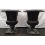 A pair of black painted cast iron Griechen style garden urns 59cm high 52cm diameter.