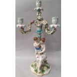 Porcelain Dresden three arm candelabra depicting a mother and child, 49cm tall.