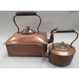 An antique square shaped copper stove kettle together with another.