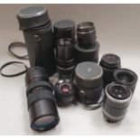 A collection of camera lenses to include Optomax, Nikon etc.