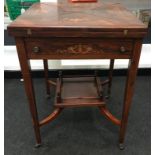 Edwardian inlaid rosewood envelope card table. The top decorated with urns and scrolled flowers,
