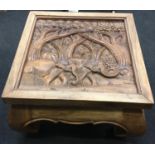 Ornately carved hard wood coffee table depicting elephants 42x60x60cm