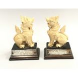 Pair oriental ivory Foo dogs with silver metal inscribed plates
