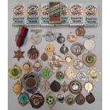 A box of medals, badges and 6 sets of military type cigarette cards.