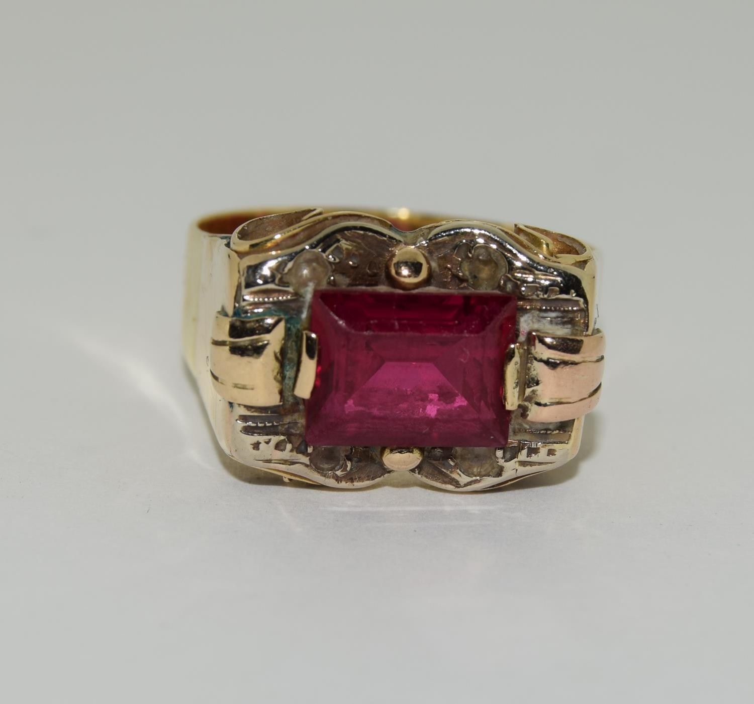 Yellow metal ruby gents signet ring.