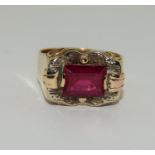 Yellow metal ruby gents signet ring.