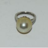 An 18ct white gold large south sea lemon cultured pearl ring set as a diamond eternity ring size M