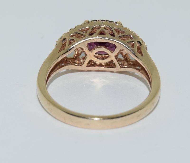 A 14ct rose gold garnet and white sapphire dress ring. - Image 3 of 6