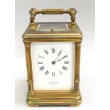 Brass cased striking carriage clock on Corinthian columns retailed by John Walker London ,with key