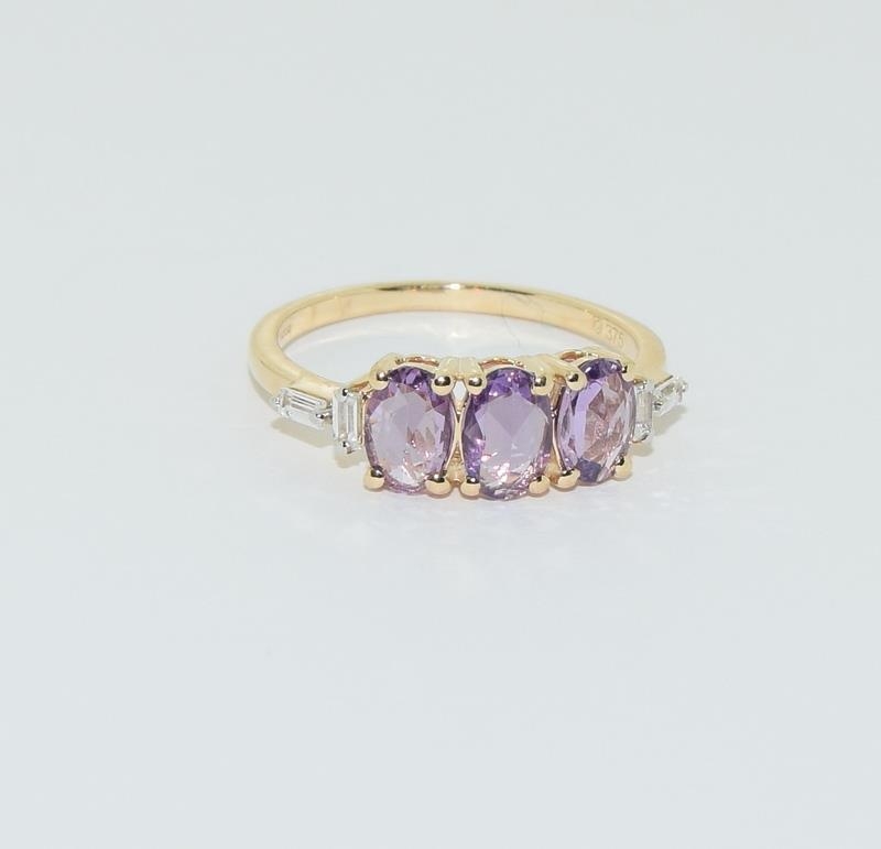 A 9ct purple sapphire 3 stone ring. Size L