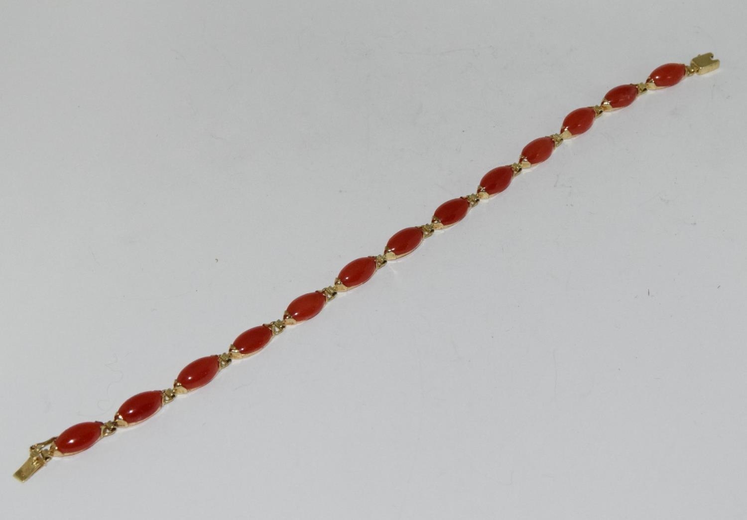 A Dainty natural not dyed coral and 14ct gold bracelet.