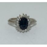 An 18ct white gold ladies diamond and sapphire ring, Size L