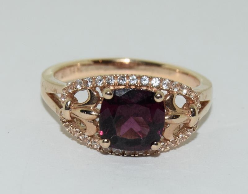 A 14ct rose gold garnet and white sapphire dress ring.