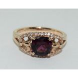 A 14ct rose gold garnet and white sapphire dress ring.