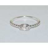 A silver ring with oval stone to centre, Size T 1/2.