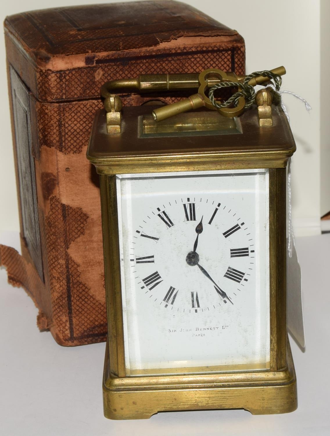 Brass striking carriage clock in case.