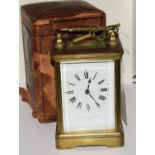 Brass striking carriage clock in case.