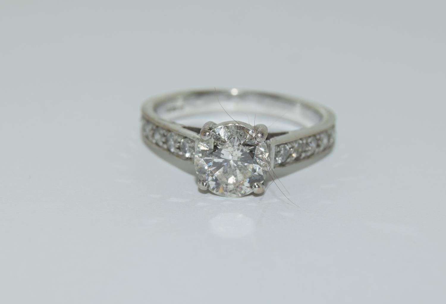 An 18ct white gold ladies diamond solitaire with diamond shoulders centre stone approx 1.3ct side