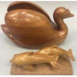 A quality wood carved treen Swan 38x22cm together with a pair of dolphins 27x14cm.