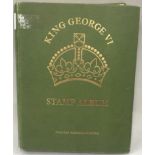 Green album of King George VI stamps.