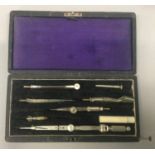 Three antique cased writing sets.