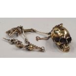 A brass Albert style watch chain with scull adornment