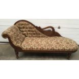 Mahogany chaise longue upholstered in a floral fabric with brass stud edging and a carved swan motif