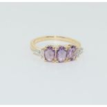 A 9ct purple sapphire 3 stone ring. Size L
