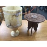 Carved round lamp table together with an alabaster table lamp.