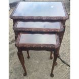 A nest of three mahogany glass topped tables the largest measuring 55x53x40cm.