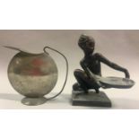 Art Deco spelter figure and a modernist pewter teapot.