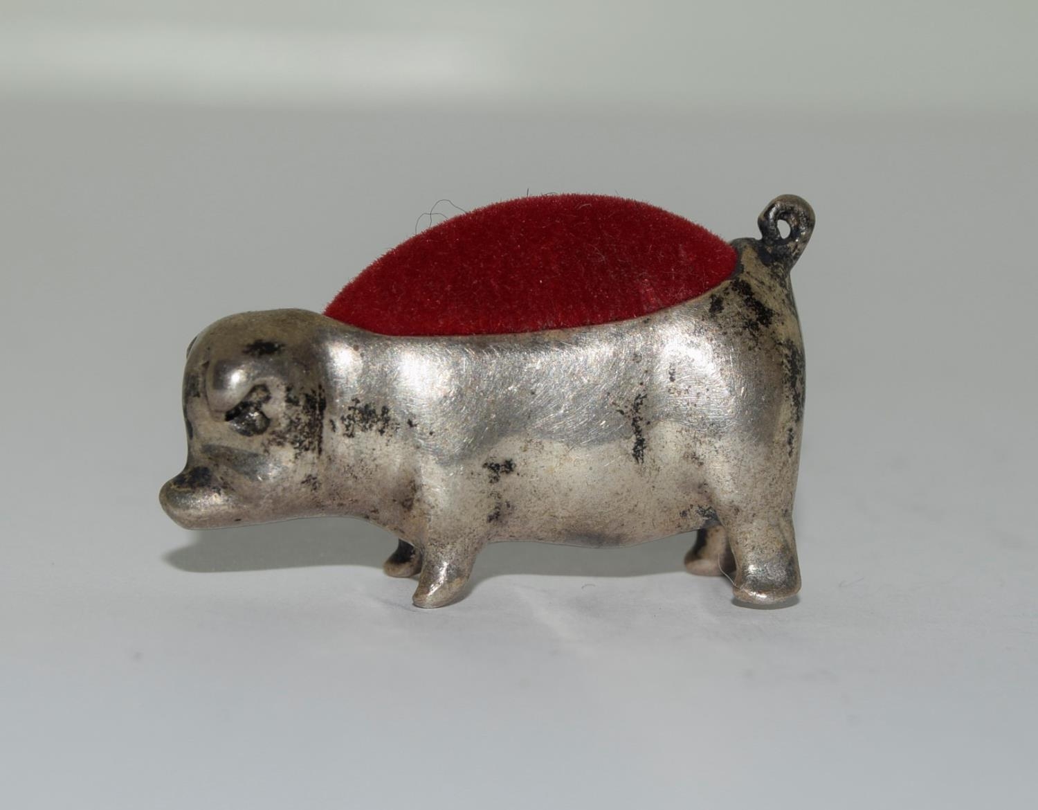 Silver pin cushion in the form of a pig