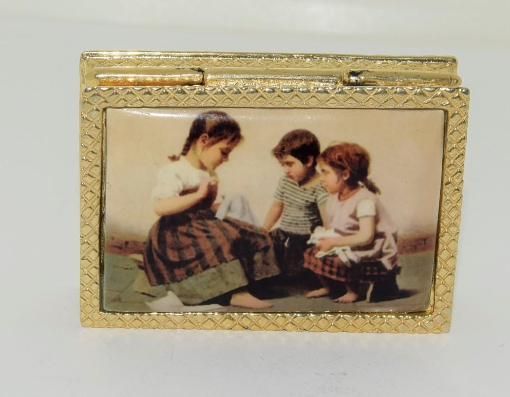 18ct gold plate and enamel pill box depicting 3 children