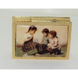 18ct gold plate and enamel pill box depicting 3 children