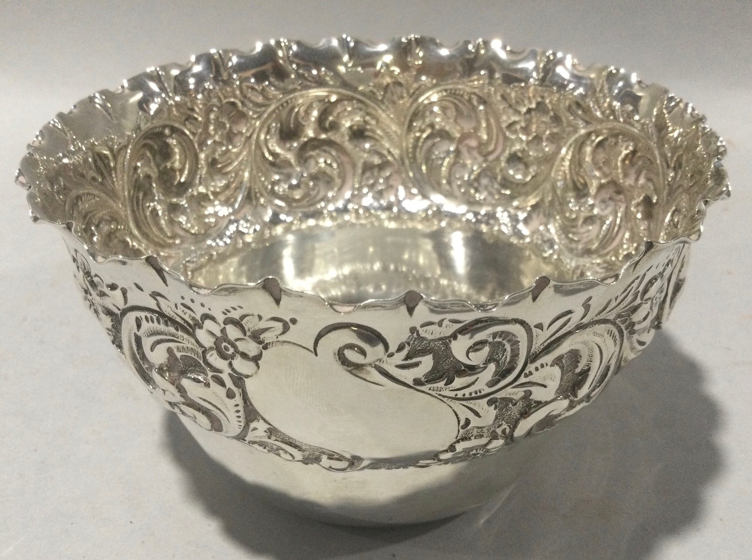 Silver hallmarked embossed bowl with fluted rim weight 170g.