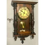 Mahogany wall clock with key and pendulum